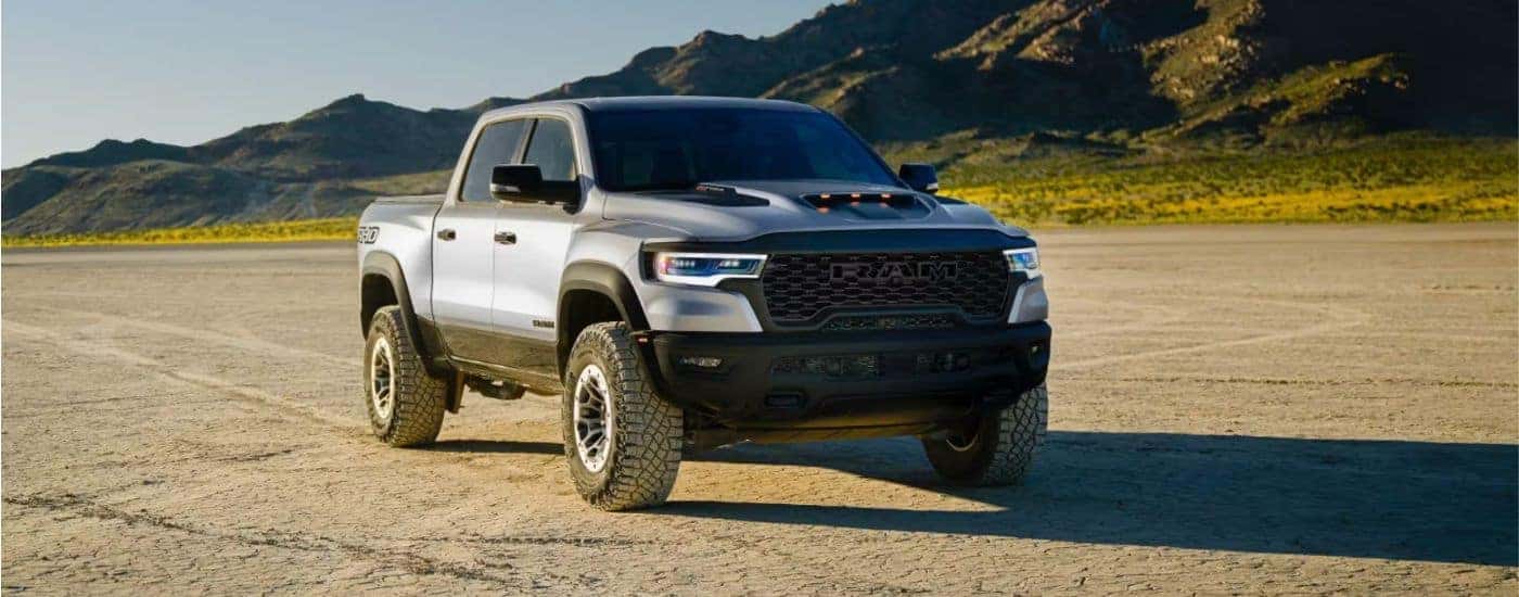 Silver 2027 Ram 1500 parked off-road in the mountains.