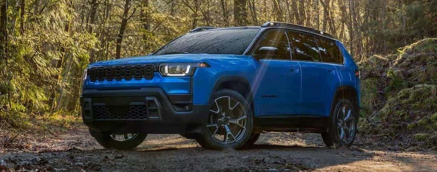 A blue 2026 Jeep Cherokee parked offroad.